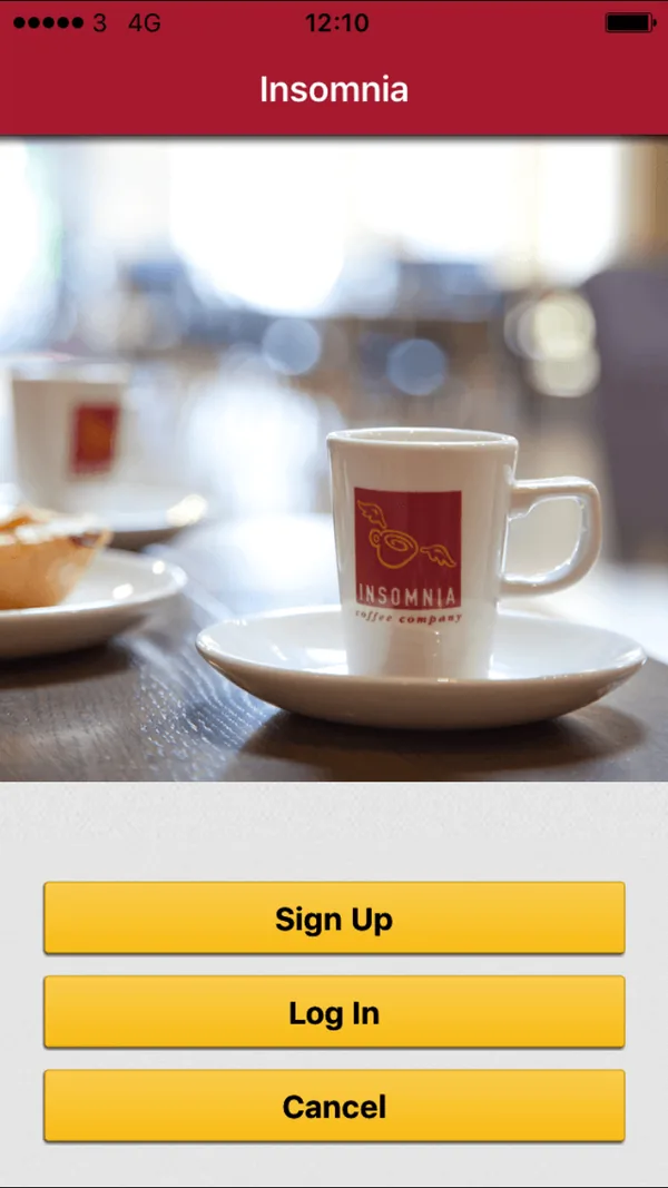Legacy start screen: a photo of an Insomnia cup above stacked yellow Sign Up, Log In and Cancel buttons